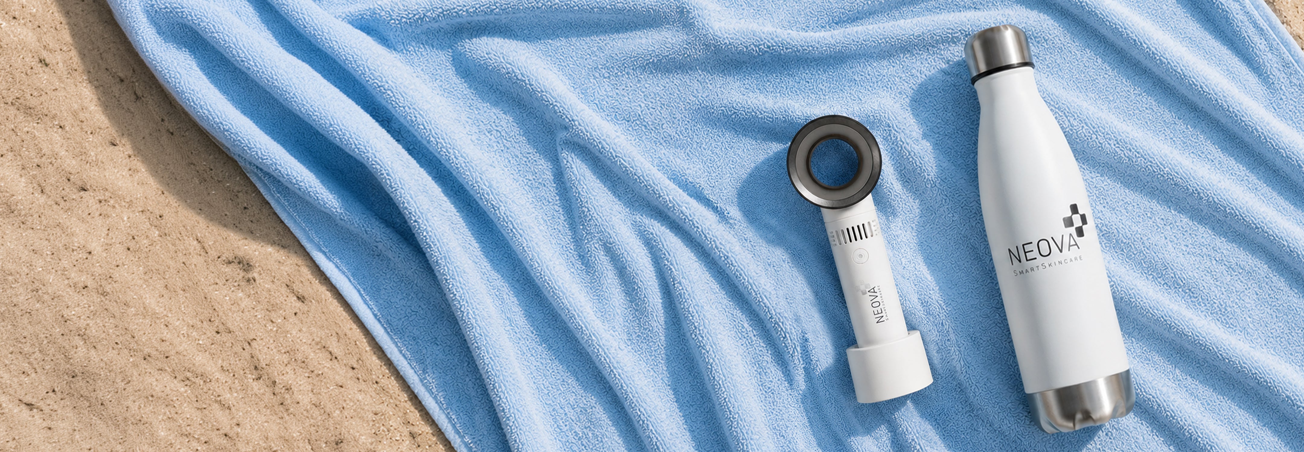 NEOVA - homepage - bottle + fan gwp - A white stainless steel water bottle and a white handheld fan with a circular lens-like top, placed on a light blue towel over a sandy surface. The fan and bottle show the brand name NEOVA.