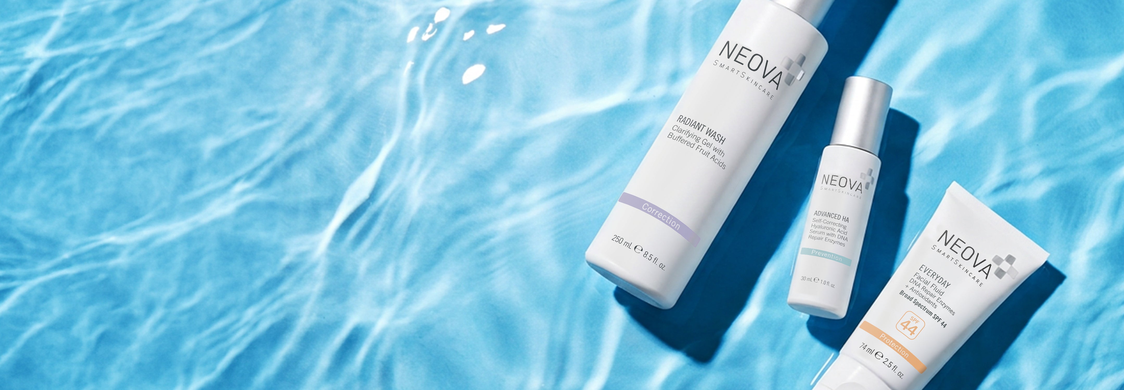 NEOVA - homepage - hero - summer skincare - desktop - Three NEOVA summer skin care essentials against a blue-water textured background