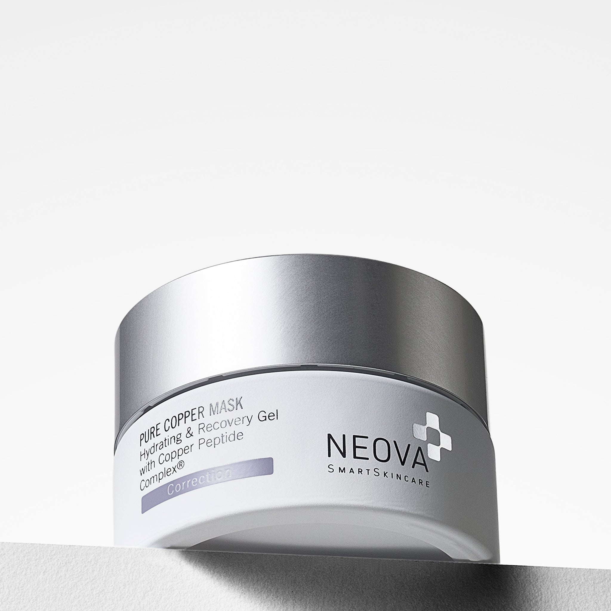 NEOVA Pure Copper Mask in a white cosmetic jar. The front label identifies it as a "Hydrating & Recovery Gel with Copper Peptide Complex®", categorizing it under a light purple "Correction" banner. The jar is topped with a flat, brushed silver screwcap and stands on a white ledge against a clean, bright minimalist background.