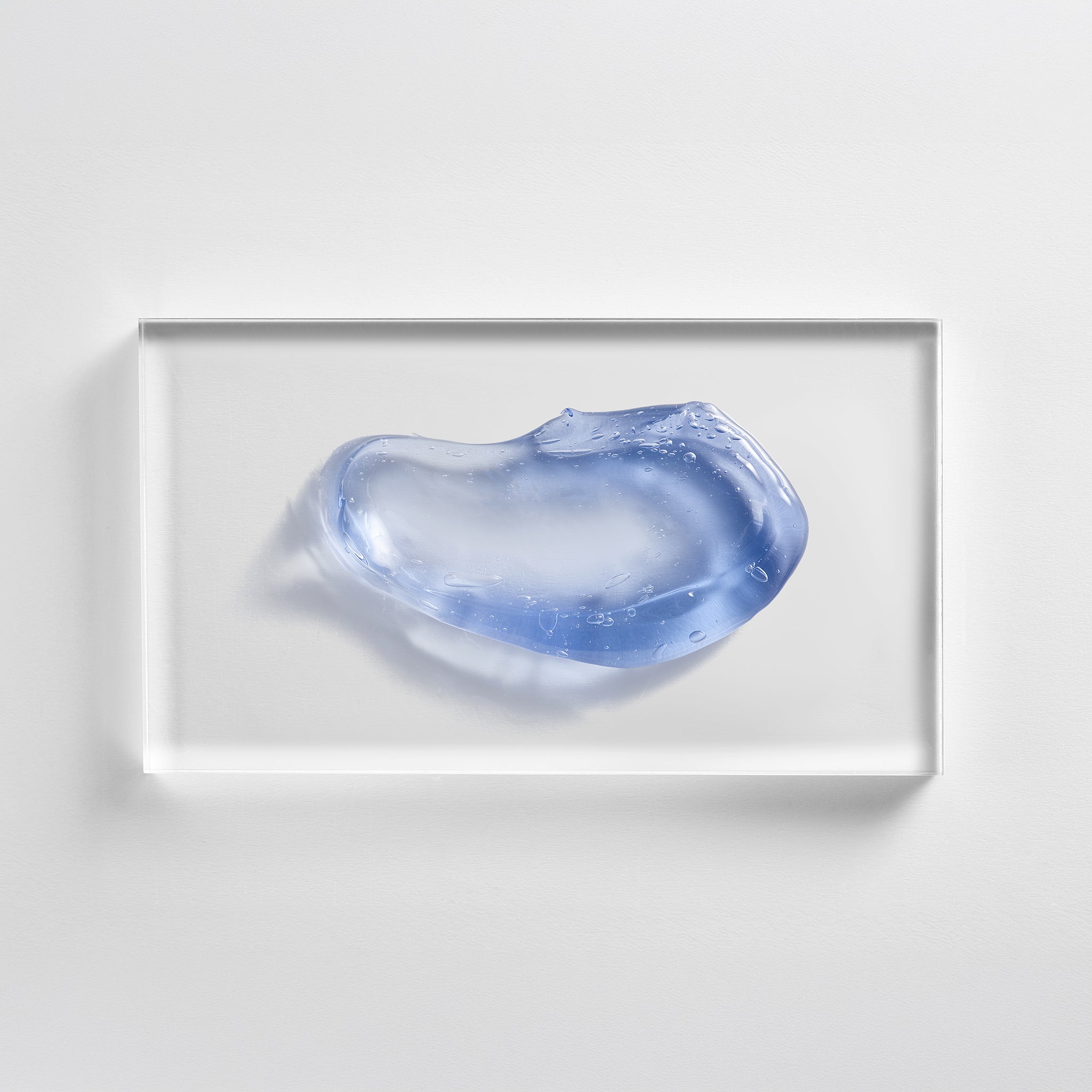 NEOVA Pure Copper Mask on a clear acrylic square. The top-down, square macro view shows the mask is a vibrant, translucent light blue/periwinkle gel with a thick, glossy, and cooling appearance. It is centered and brightly lit against a textured white background, showcasing the formula's smooth and jelly-like consistency.