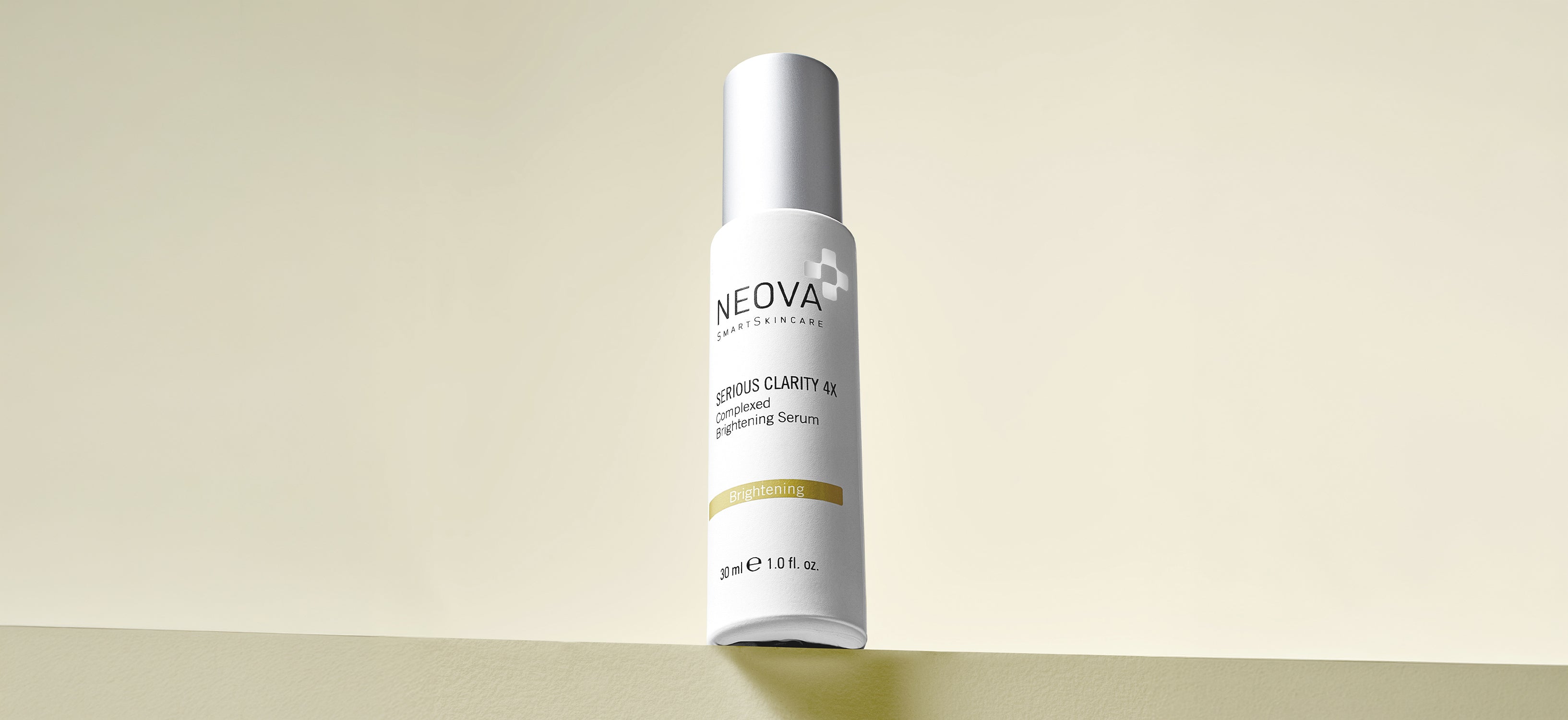 NEOVA - Serious Clarity 4x - grid breaker - white skincare pump bottle with NEOVA logo and a gold "Brightening" label, displayed upright against a warm yellow-green background