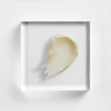 NEOVA Serious Clarity 4X serum on a clear acrylic square. The top-down, square macro view shows the serum is a smooth, opaque white cream with a slight glossy sheen and a lightweight consistency. It is centered and brightly lit against a textured white background, showcasing its refined and fluid texture.