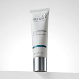 NEOVA Serious Microderm Scrub in a white squeeze tube. The front label describes it as an exfoliant for perfecting skin polish and features a dark blue "At Home Peels" banner. The tube stands upright on its flat, brushed silver screw-cap and contains 2.0 oz (60 ml). It is set on a white ledge against a clean, bright minimalist background.
