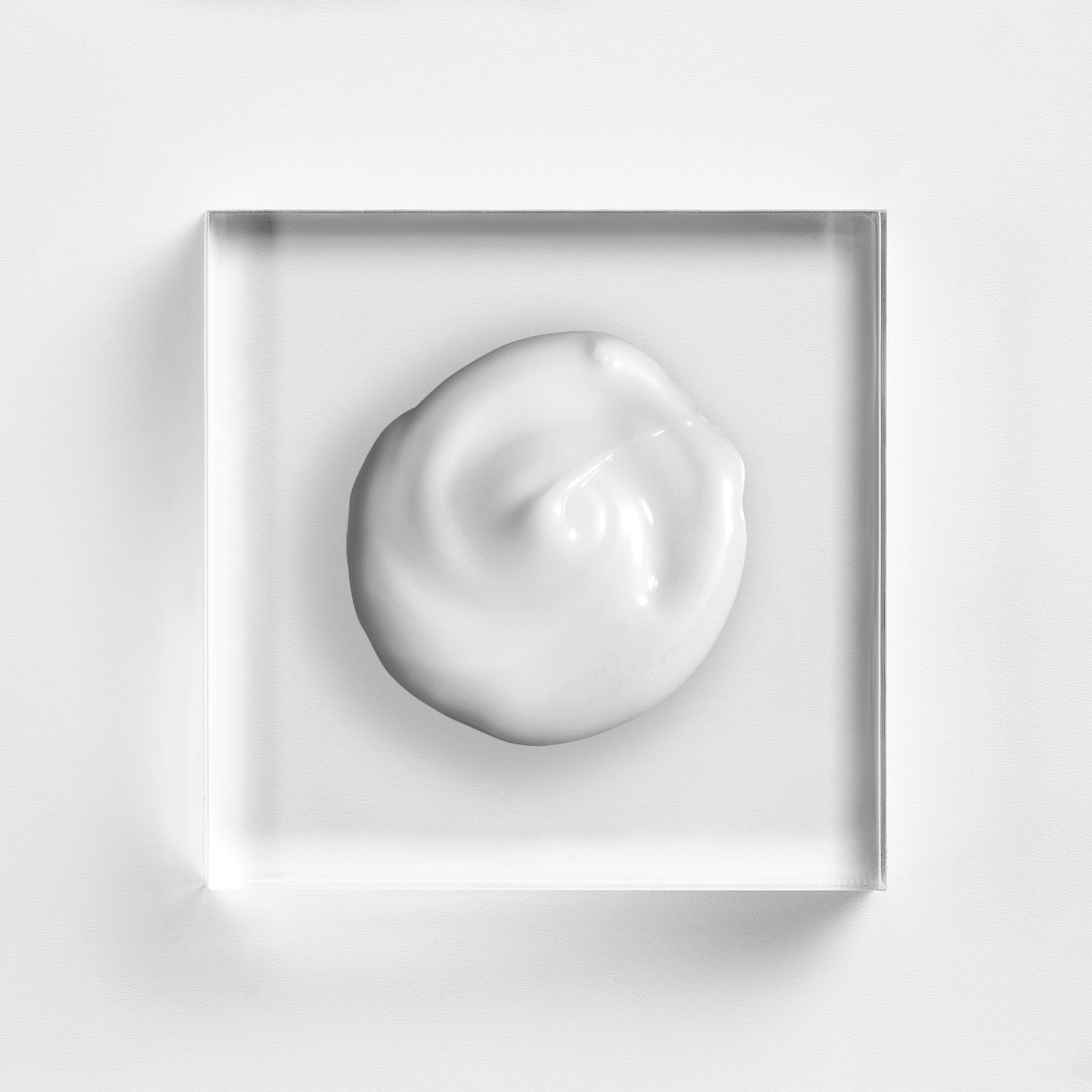 NEOVA Tricomin Fortifying Conditioner texture closeup, highlighting the rich, clinical formula designed to strengthen thinning hair and improve scalp health. This nourishing copper peptide conditioner is shown as a creamy white dollop on a minimalist glass background, emphasizing its professional-grade quality.