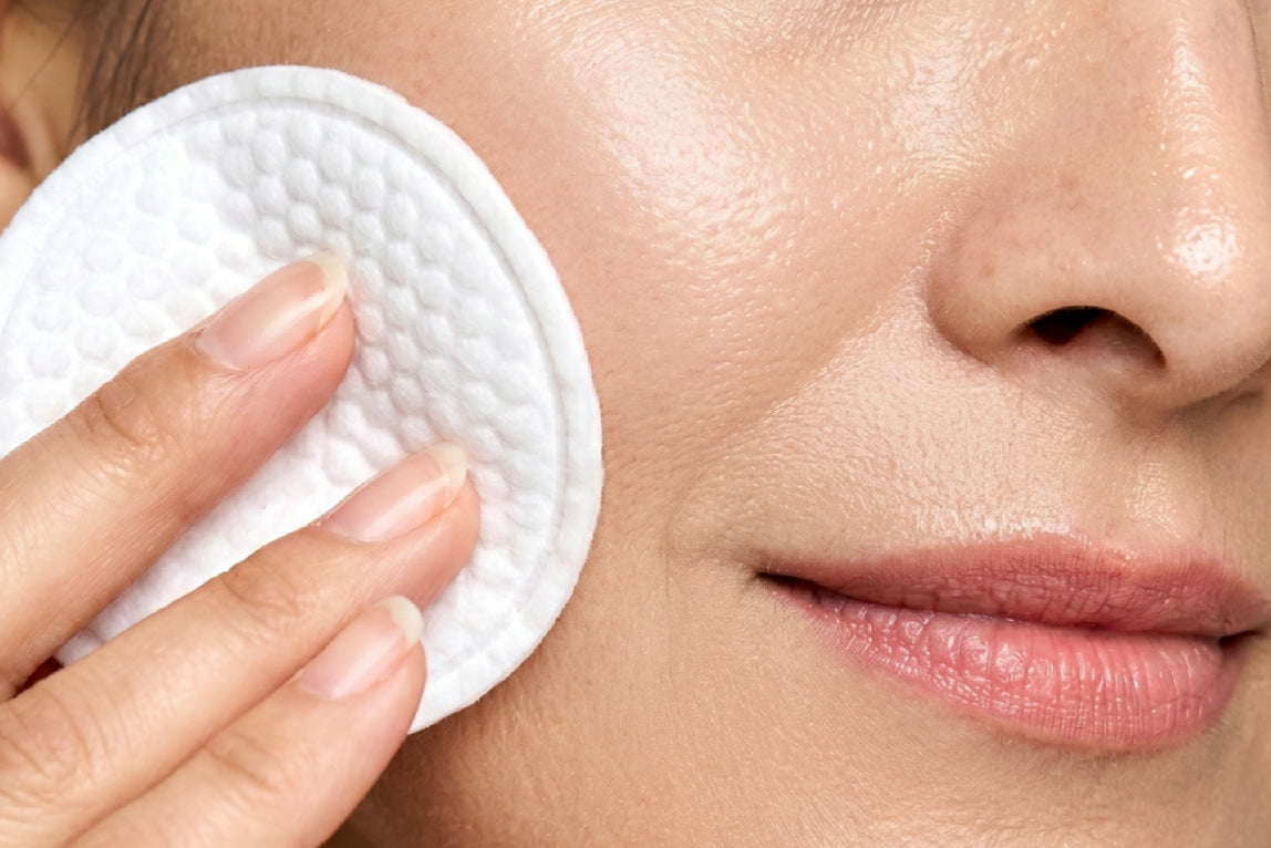 NEOVA 5 Second Daily Peel – application: Close-up of face showing exfoliating treatment being applied with a cotton pad to remove dead skin cells and refine skin texture.