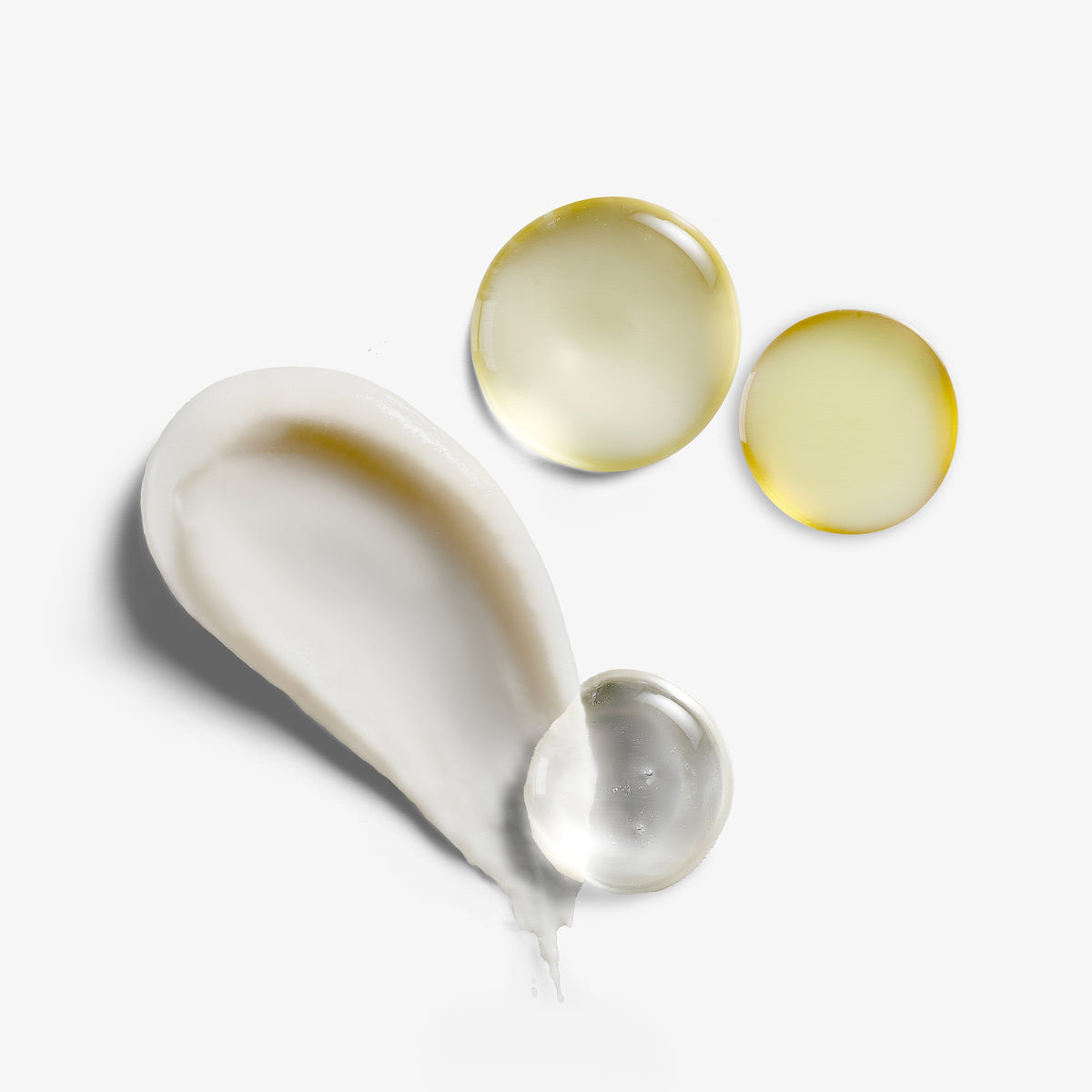 NEOVA - Glow & Brightening System - A collage of four cosmetic smears on a clean, white background. There is a  creamy white product, two translucent yellow droplets and one clear gel droplet to display the products in the Glow & Brightening skincare system