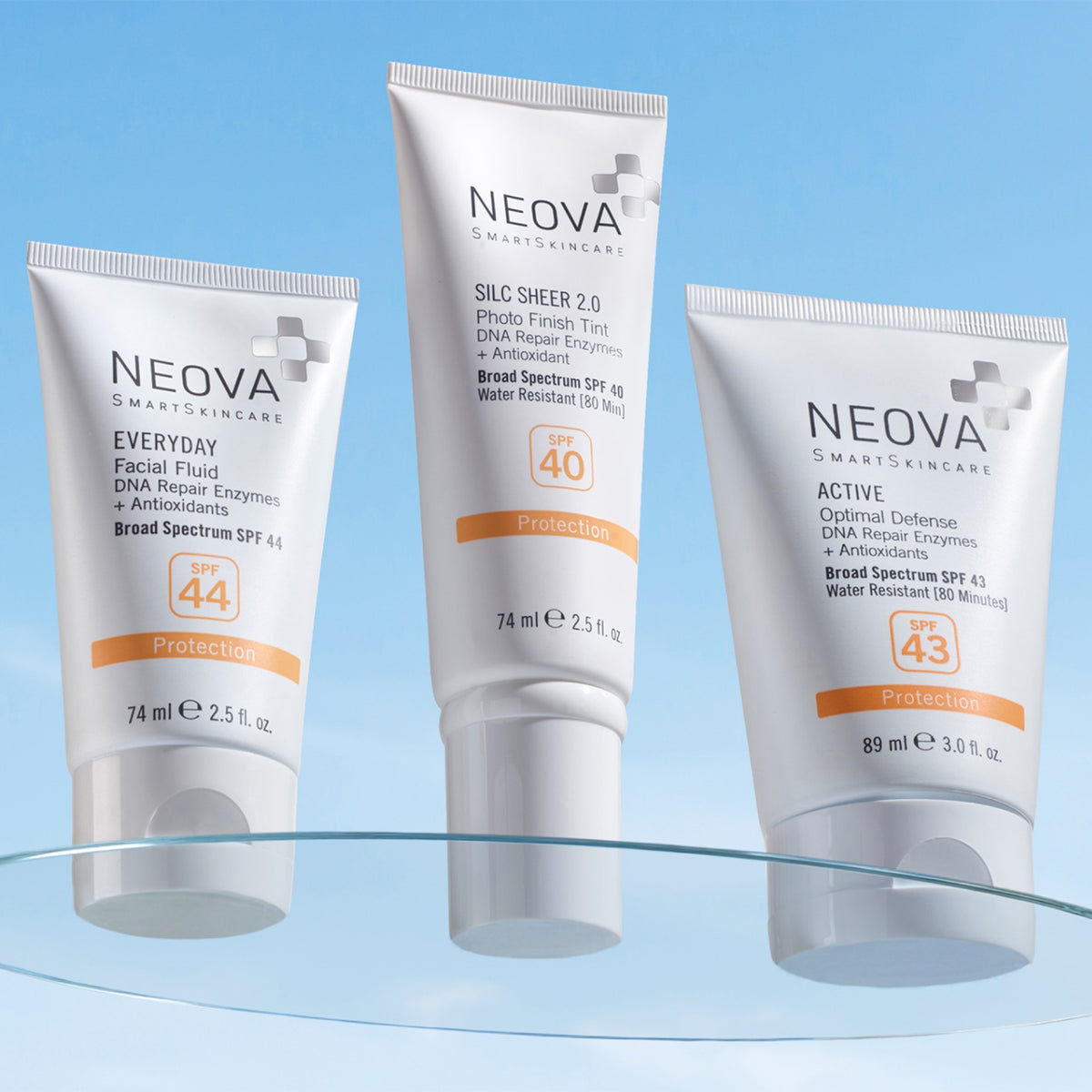 NEOVA - SPF Morning Routine Blog - Three NEOVA sunscreen products arranged on a glass surface against a blue background, representing a key step in an SPF-morning-routine for daily sun protection and skincare.