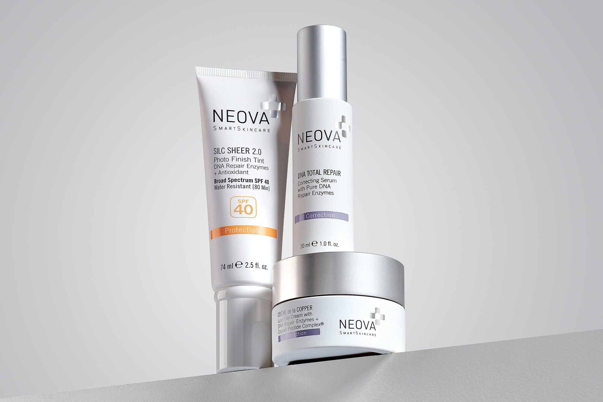 NEOVA - About Neova - Mega Menu - Three NEOVA skin care products on a shelf against a grey background