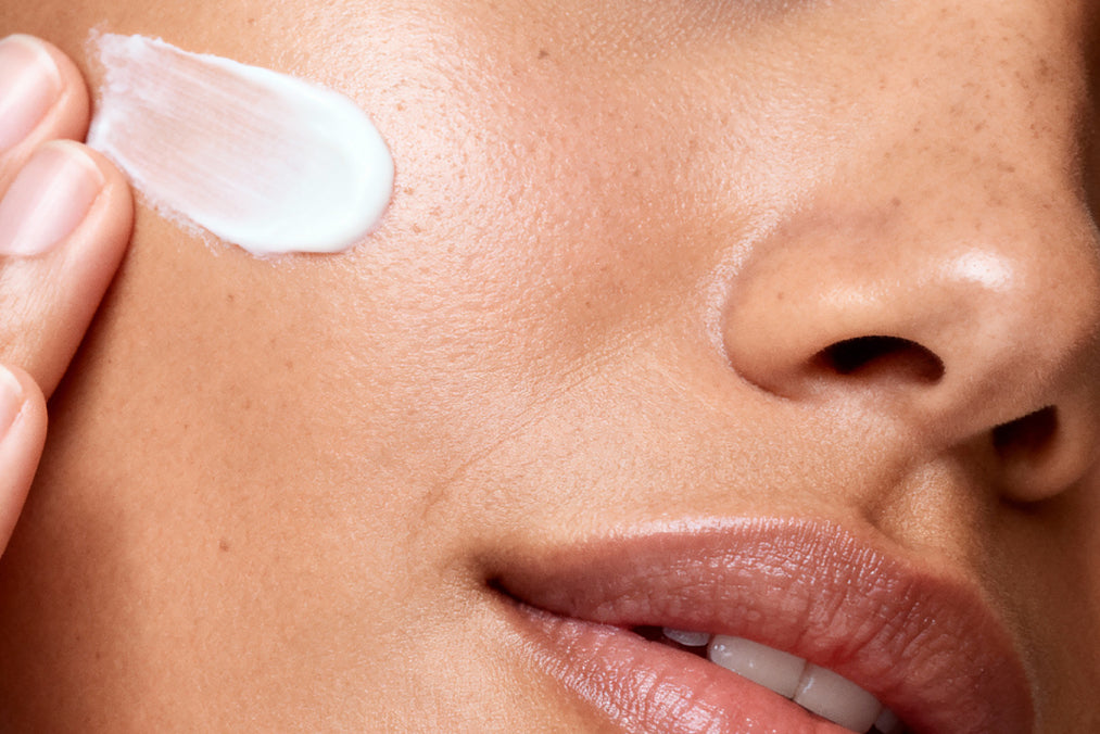 NEOVA Active – application: Close-up of cheek showing targeted SPF treatment being applied to improve skin clarity, refine texture, and support a more even-looking complexion.