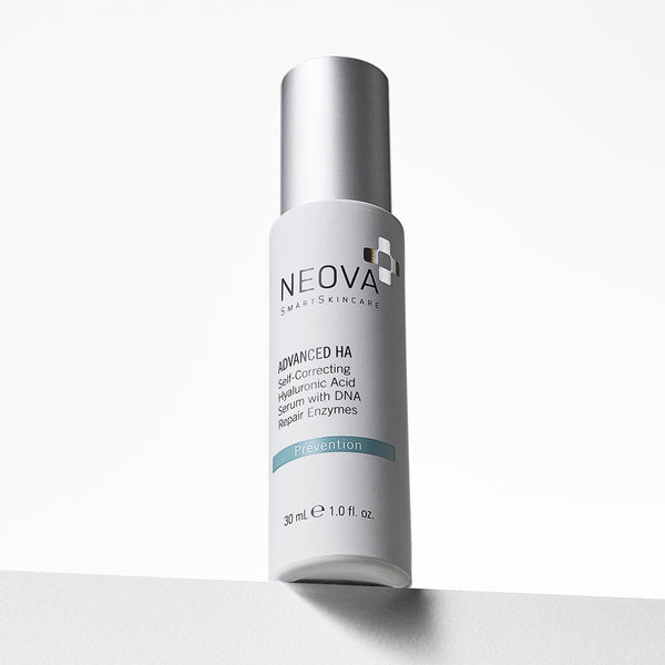 NEOVA Advanced HA in a sleek, white bottle. The front label identifies it as a "Self-Correcting Hyaluronic Acid Serum with DNA Repair Enzymes" for "Prevention." The bottle features a brushed silver cap and contains 1.0 fl. oz. (30 ml). It is positioned on a white ledge against a clean, bright background with soft shadows.