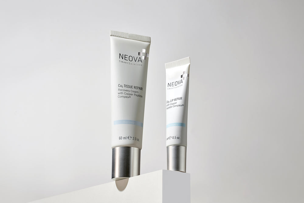 NEOVA Cu3 Tissue Repair and Cu3 Lip Repair on a block ledge representing copper peptide technology and skin repair science.