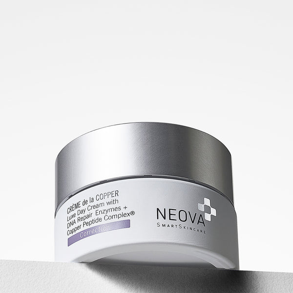 NEOVA Crème de la Copper, a luxe day cream with DNA repair enzymes and Copper Peptide Complex, in a jar with a reflective cap set against a minimalist white backdrop. 