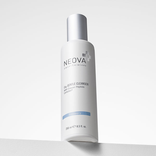 NEOVA Cu3 Gentle Cleanser containing a Copper Peptide Complex® formula. The front label of the tall, white cylindrical bottle categorizes it under a light blue "Recovery" banner. The bottle features a brushed silver cap and contains 8.5 fl. oz. (250 ml), shown from a low angle resting on a white surface against a bright, minimalist background.