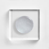 NEOVA Cu3 Gentle Cleanser on a clear acrylic block. The top-down macro view shows the facial cleanser is a transparent, colorless gel with many tiny, suspended oxygen bubbles throughout, giving it a fresh and aerated appearance.