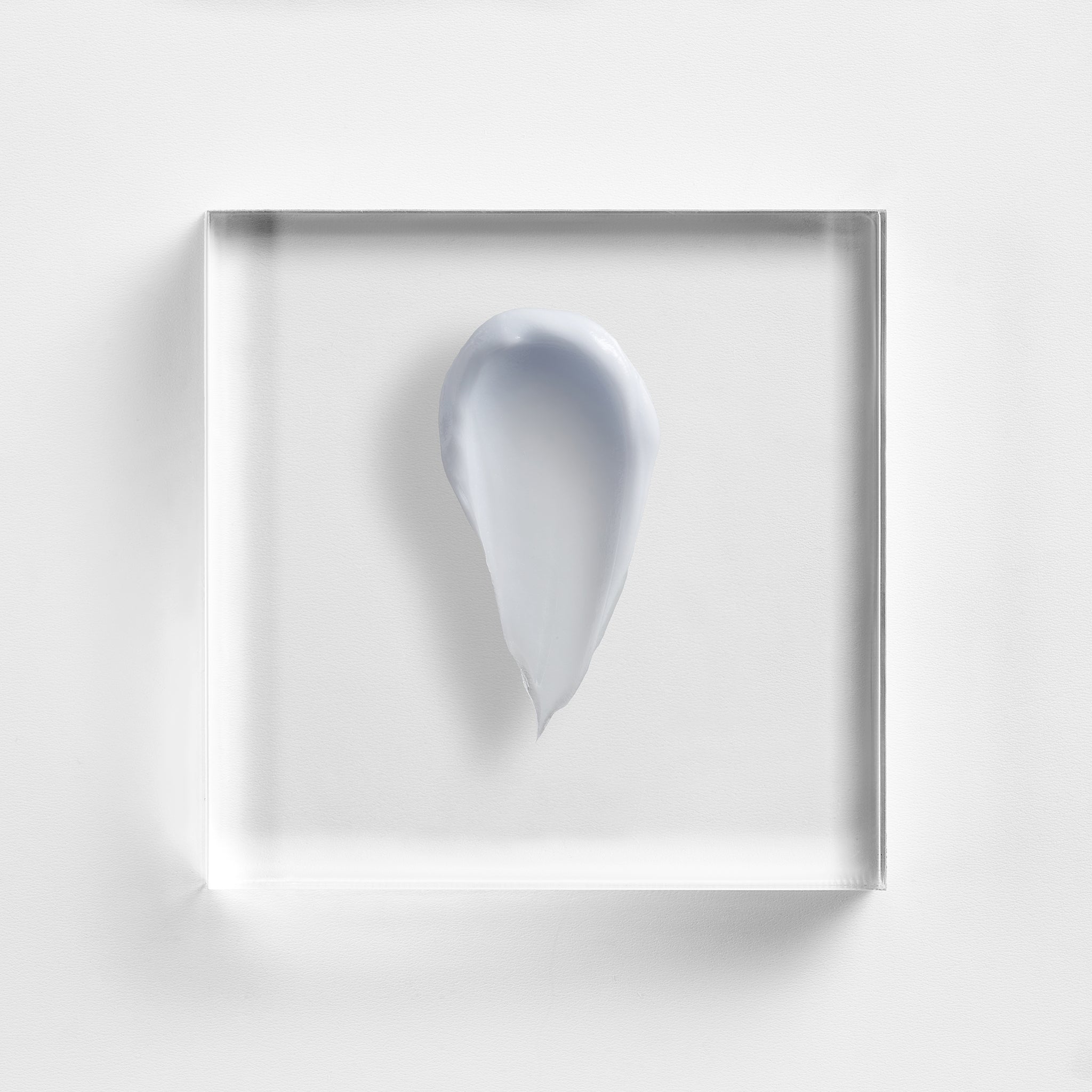 NEOVA Cu3 Tissue Repair cream on a clear acrylic square. The top-down macro view shows the cream has a distinct, pale lavender-blue tint and a thick, smooth, opaque consistency. The composition is brightly lit against a textured white background, highlighting the product's rich and soothing texture.