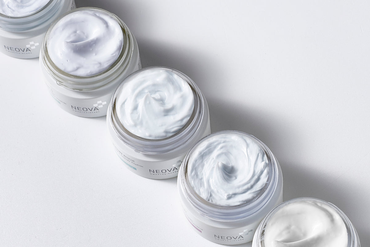 NEOVA DNA CoFactor Science Image - Image of multiple open jars of cream with smooth, whipped textures, representing DNA repair and copper peptide complex technology through rich, restorative formulations.