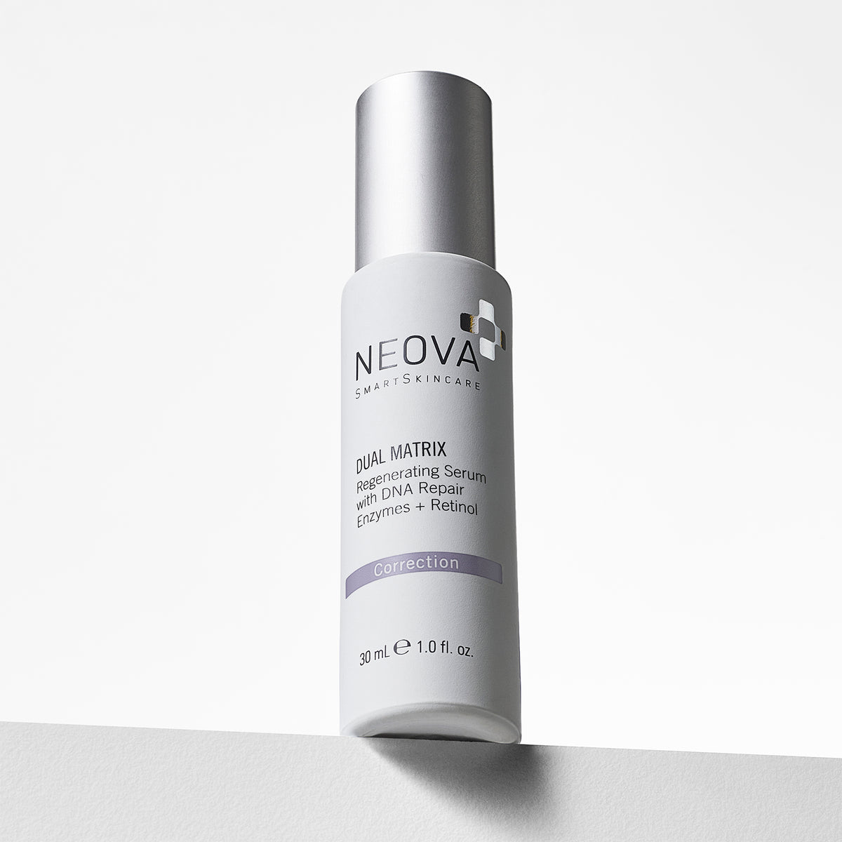 NEOVA Dual Matrix, a serum with retinol and DNA repair enzymes, in a white cylindrical bottle. The front label categorizes it under a purple "Correction" banner. The bottle features a brushed silver cap and contains 1.0 fl. oz. (30 ml). It is shown from a slightly low angle, standing on a white surface against a clean, bright minimalist background.