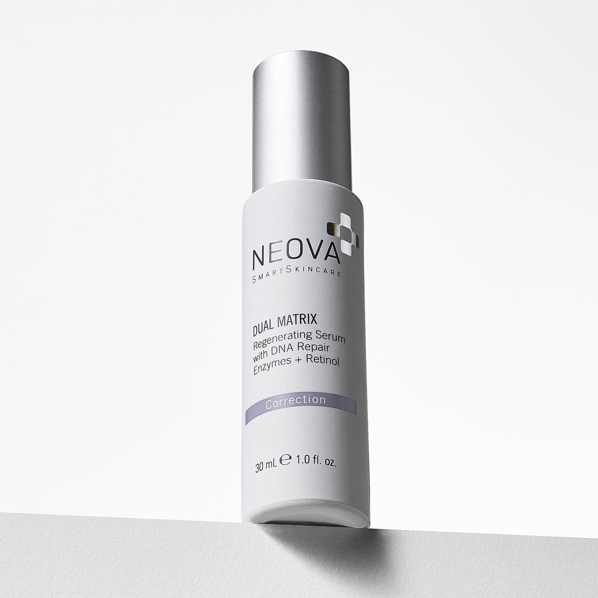 NEOVA Dual Matrix, a serum with retinol and DNA repair enzymes, in a white cylindrical bottle. The front label categorizes it under a purple "Correction" banner. The bottle features a brushed silver cap and contains 1.0 fl. oz. (30 ml). It is shown from a slightly low angle, standing on a white surface against a clean, bright minimalist background.