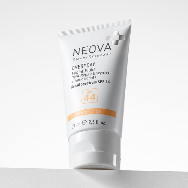 NEOVA Everyday Broad Spectrum SPF 44 sunscreen in a white cylindrical squeeze tube. The front label highlights its "Photo-Adaptive Protection" and "DNA Repair Enzymes," and categorizes it under an orange "Protection" banner. The tube features a wide, flat white cap and is shown standing upright on a white surface against a clean, minimalist background.