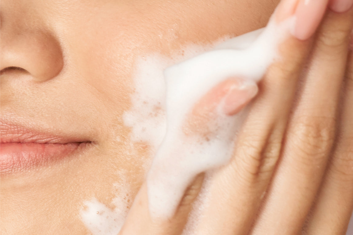 NEOVA Herbal Wash – application: Close-up of face showing foaming facial cleanser being massaged into skin to remove impurities, excess oil, and support a balanced complexion.