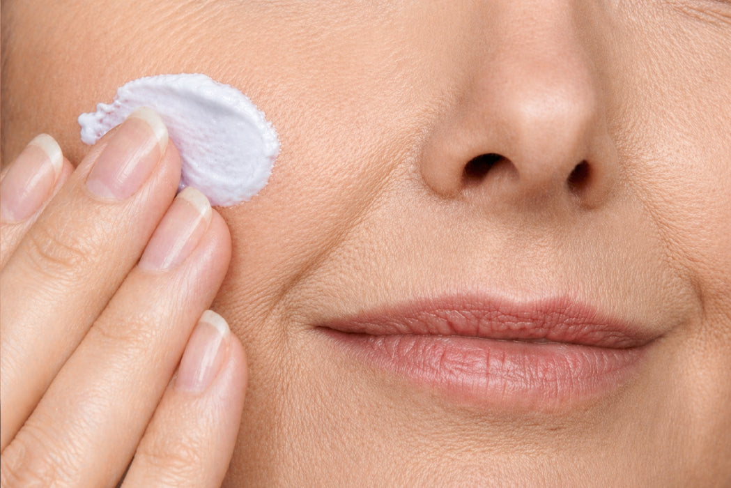 NEOVA Night Therapy – application: Close-up of cheek showing nighttime treatment being applied to hydrate skin, improve elasticity, and reduce visible signs of aging.