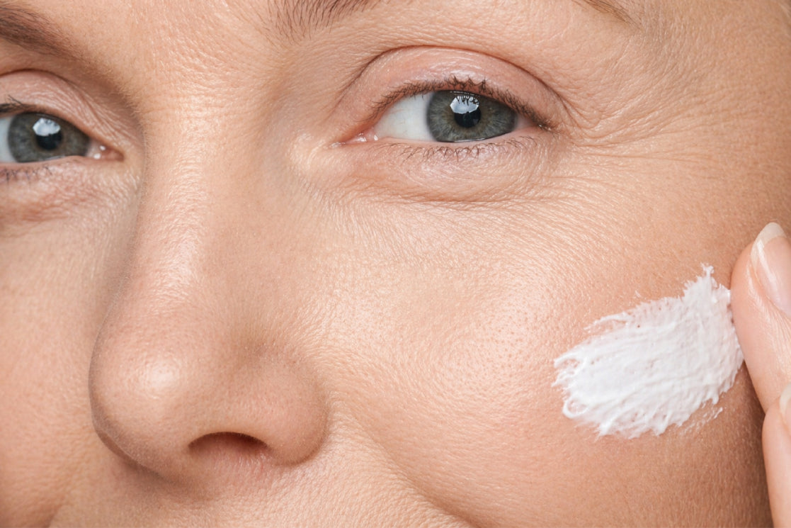 NEOVA Overnight Repair – application: Close-up of cheek showing nighttime treatment cream being applied to support skin renewal, improve tone, and restore moisture overnight.
