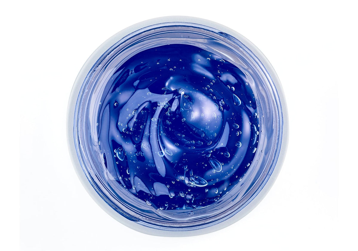 NEOVA - Pure Copper Mask - Top-down view of a blue gel facial mask with copper peptides in a clear container on a white background