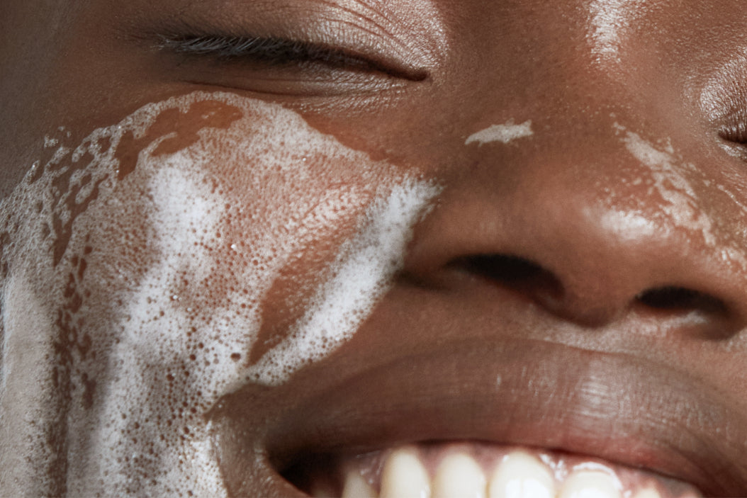 NEOVA Radiant Wash – application: Close-up of face showing foaming facial cleanser being worked into skin to remove impurities, excess oil, and brighten dull complexion.