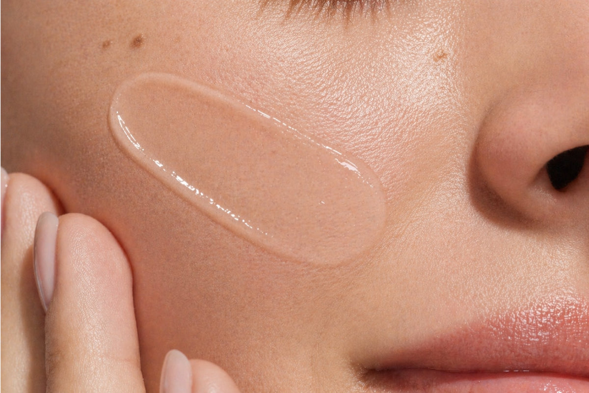 NEOVA Serious Reveal Exfoliator – application: Close-up of cheek showing exfoliating treatment being applied to resurface skin, improve texture, and enhance overall skin clarity.