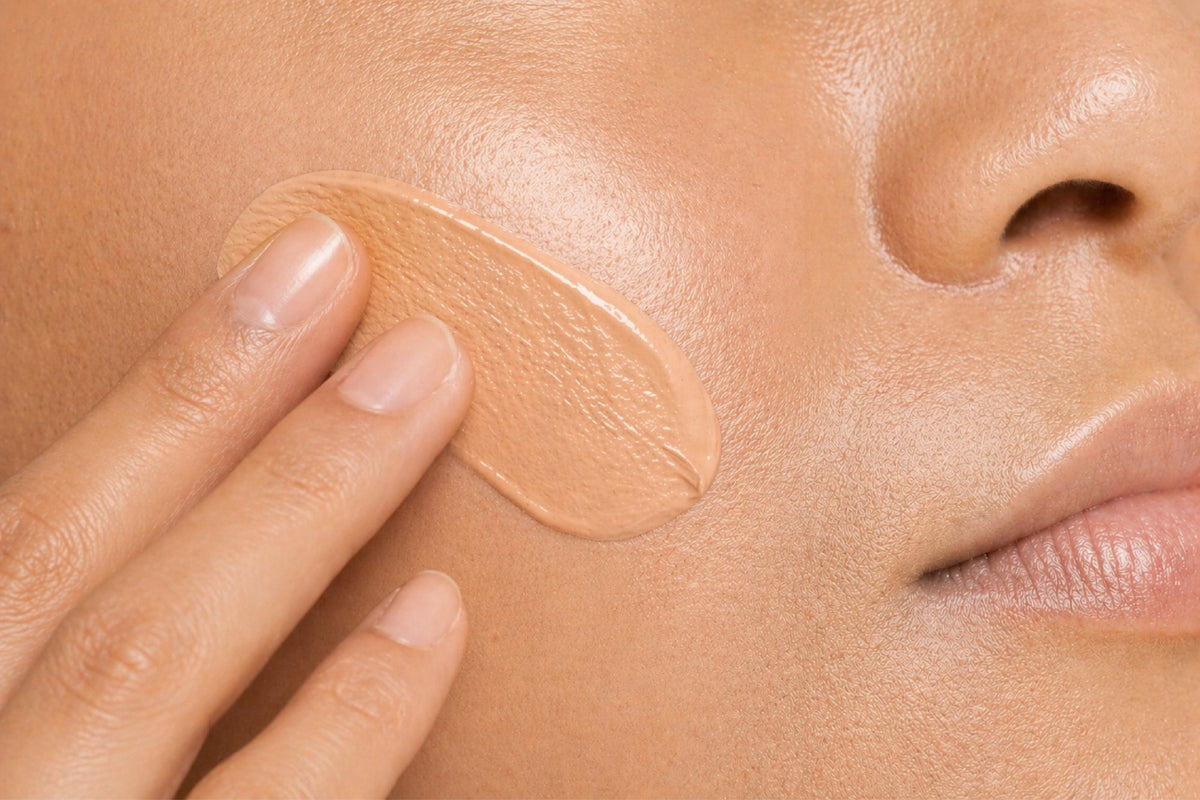 NEOVA Silc Sheer 2.0 – application: Close-up of cheek showing sheer sunscreen being applied to protect against UV damage while providing lightweight hydration and a smooth finish.